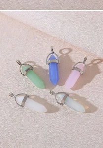 Detailed view of hexagonal amethyst and quartz crystal pendants with silver metal clasps