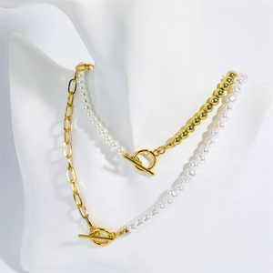 Close-up of double layer necklace with pearls and gold beads on white mannequin