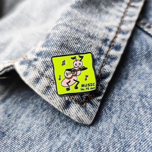 Cartoon ant playing guitar enamel pin on denim background with MUSIC No.70 text