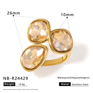 Detail view of a 26mm gold stainless steel ring with three champagne crystals and dimensions