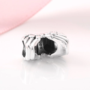 S925 sterling silver angel wing charm bead with detailed texture on a white surface