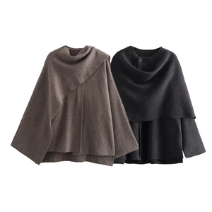 Detail of wool-blend knit capes in tan and charcoal grey with thick scarf-style collars