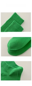 Detailed view of neon green crew socks with ribbed cuffs and reinforced toe and heel