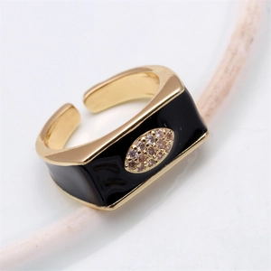 Macro shot of gold rectangle ring with black enamel and pavé rhinestones in the center