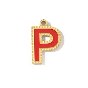 Detail of a red enamel letter P pendant with gold-plated stainless steel borders