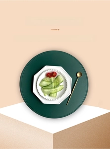 Detailed close-up of dark green PVC placemat with waterproof faux leather texture