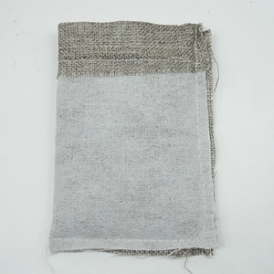 Inside view of a linen drawstring jewelry pouch showing inner lining and stitching detail