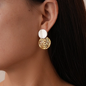 Detail view of 18k gold plated geometric earrings with silver and gold color blocking