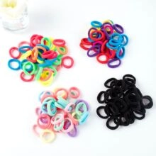 Detailed view of elastic mini hair ties in vibrant, pastel, and black color sets