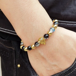 Adjustable stainless steel bead bracelet with leopard head charm and natural stone on wrist