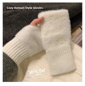 Detail of white plush fingerless gloves showing knit texture and faux fur finish