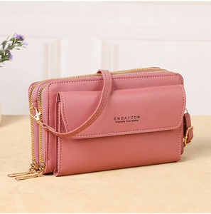Detail view of pink PU leather crossbody phone bag with triple gold-tone zippers