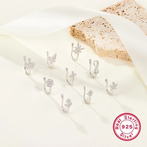 Detailed collection of 925 sterling silver non-piercing star and crown nose clips with zircons