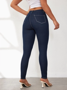 Rear view of high-waisted skinny dark blue jeans with detailed white contrast stitching