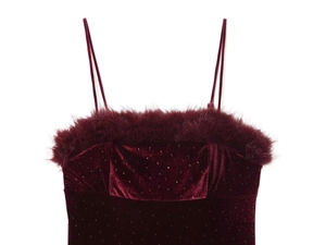 Detail of burgundy velvet dress with faux fur trim and shimmering rhinestone accents