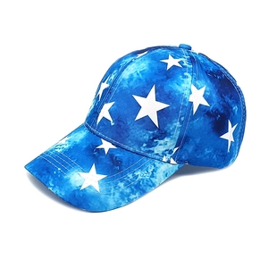 Detailed side view of tie-dye baseball cap featuring white star patterns and curved brim