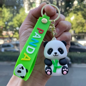 Detail of cute 3D panda keychain with green bamboo and silicone PANDA wrist strap