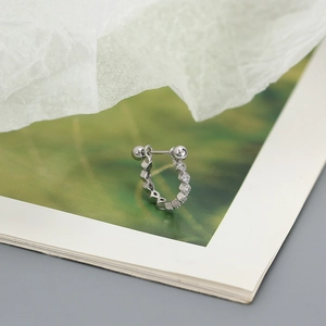 Close-up of S925 silver geometric hoop earring with zircon and hexagonal relief