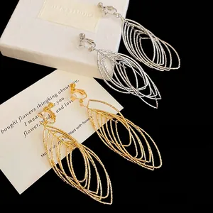 Hollow oval metal leaf ear clips in gold and silver finish with zircon accents