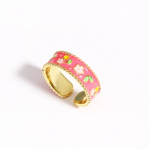 Detail of pink enamel flower ring with golden beaded edges and adjustable open band