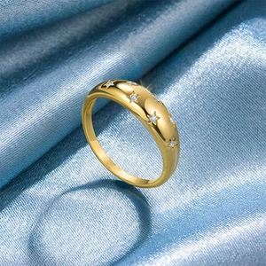 Minimalist gold dome ring with star-set cubic zirconia on elegant blue silk