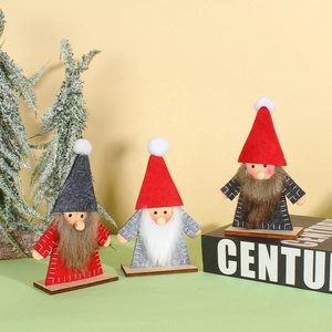 Three handmade Christmas gnomes with wooden bases and felt hats for holiday decor