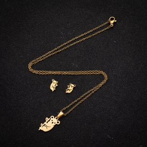 Golden stainless steel jewelry set featuring cute cartoon bear pendant and stud earrings
