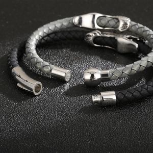 Detail of woven leather bracelets with silver magnetic clasps in black and grey