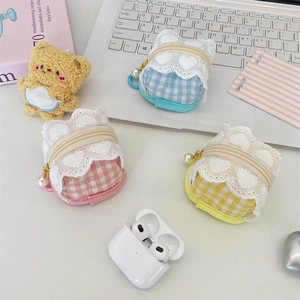 Close-up of plush plaid earphone case with lace trim, pearl zipper, and bear charm