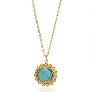 Detail of 18k gold vintage pouch pendant with turquoise stone on a classic link chain