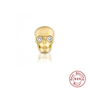 Macro shot of 925 sterling silver skull ear stud with glittering clear zircon eyes
