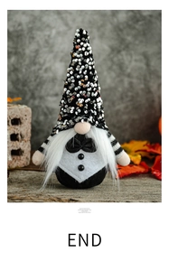 Close-up of a groom gnome figurine with black sequins and bow tie on wooden table