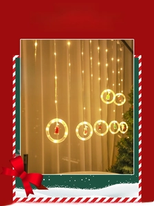 Close-up of LED curtain lights with miniature Santa and reindeer figures inside rings