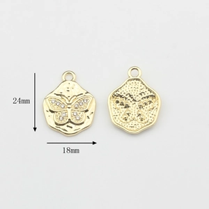 Detailed view of gold butterfly pendants with rhinestones measuring 24mm by 18mm
