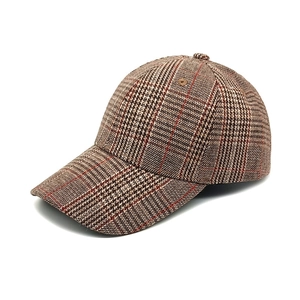 Detailed view of retro glen plaid baseball cap in brown and beige tweed texture