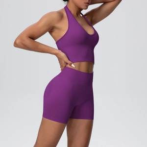 Macro detail of seamless purple ribbed knit fabric on high waist yoga shorts and halter top