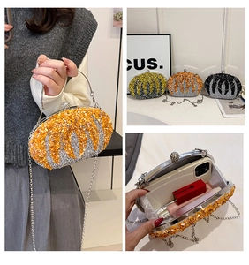 Detail of luxury evening clutch with radiant beads, metal frame, and detachable chain strap