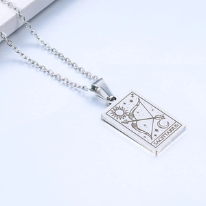 Detail of silver Sagittarius zodiac pendant with sun and moon engravings on O-chain