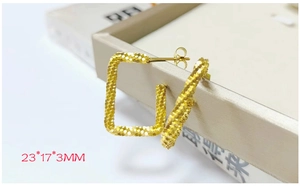 Macro view of gold rectangle stud earrings with frosted texture and size 23x17x3mm