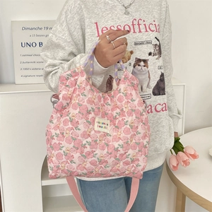 Vue détaillée du sac à main matelassé rose fleuri avec bandoulière réglable