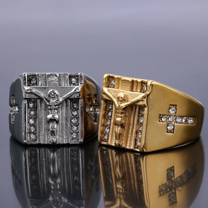 Macro detail of punk religious rings featuring gold and silver plated cross relief with crystals
