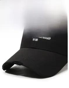 Close-up of vintage black cotton baseball cap featuring worn edges and white embroidery