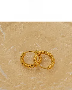 Detail of 18K vacuum gold-plated hoop earrings featuring a twisted rope texture design