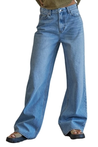 Detail of high-waisted wide-leg jeans in washed blue denim with vintage fading