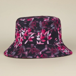 Detail view of tropical floral print on dark breathable bucket hat with pink leaves