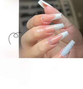 Detailed view of French press-on nails with white tips, silver glitter, and rhinestones