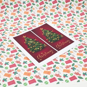 Close-up of Merry Christmas rectangular stickers featuring festive red and white tree designs