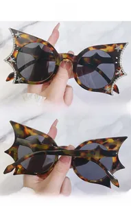 Close-up of tortoise shell bat-wing sunglasses with rhinestones and silver star accents