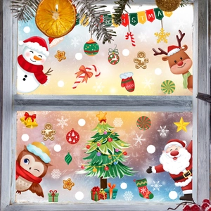Christmas window stickers with Santa, snowman and reindeer on frosty glass window pane