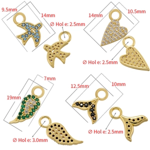 Gold micro-paved zircon charms in swallow, heart, wing and whale tail shapes with size marks